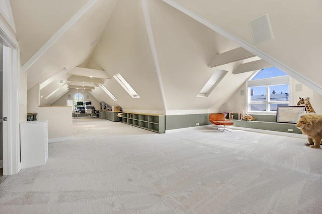 bonus room with vaulted ceiling with skylight and light carpet