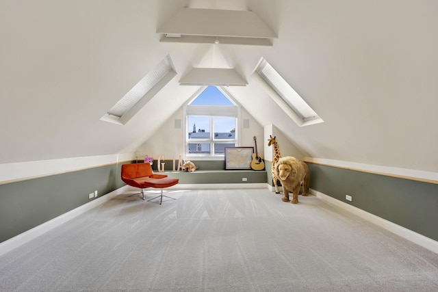 bonus room with carpet flooring and lofted ceiling with skylight