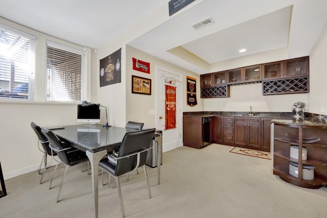 carpeted dining area featuring wet bar