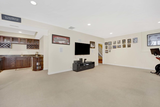 living room with light carpet and bar