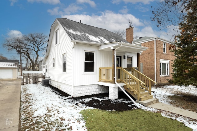 view of front of house featuring an outdoor structure, a garage, and central air condition unit