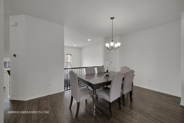 dining space with dark hardwood / wood-style floors and a chandelier