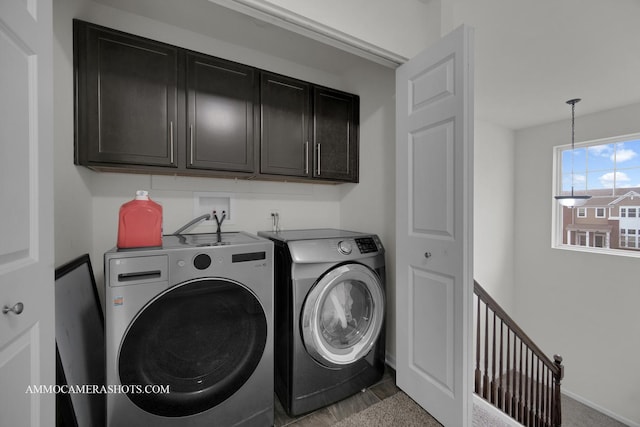 laundry area with cabinets and washing machine and dryer