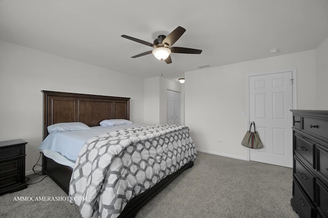 carpeted bedroom with ceiling fan and a closet