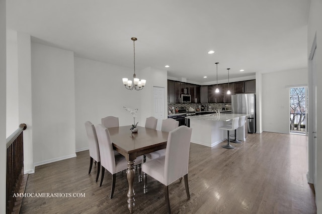 dining room featuring a notable chandelier and dark hardwood / wood-style floors