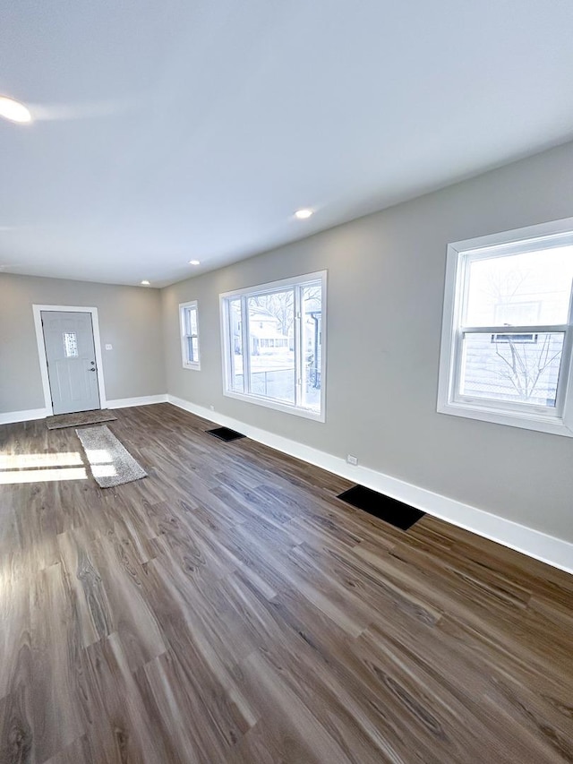 unfurnished living room with dark hardwood / wood-style floors