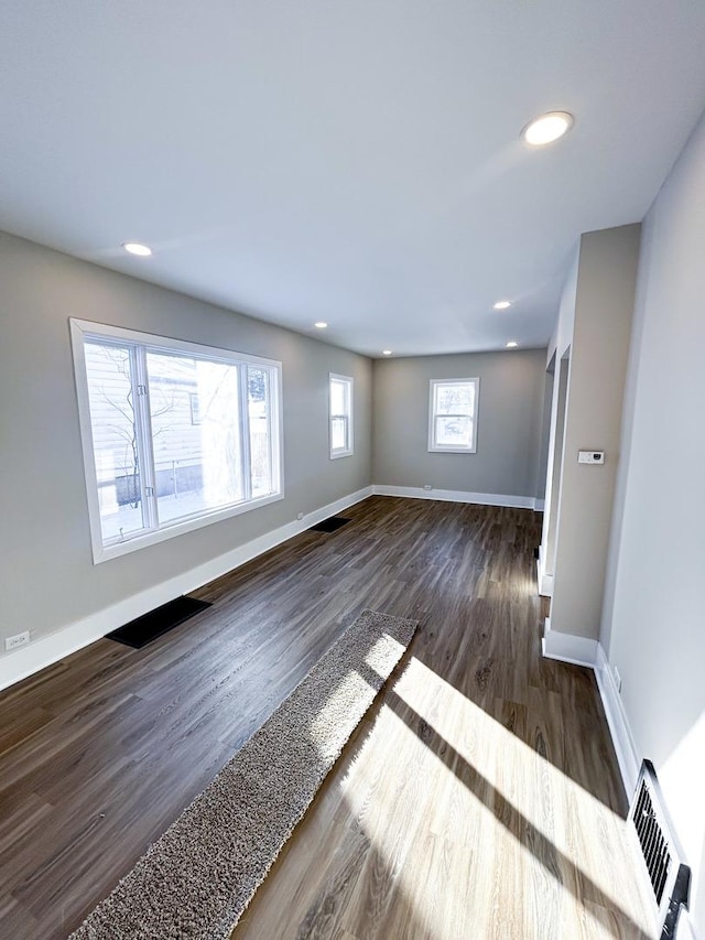 unfurnished room featuring dark wood-type flooring