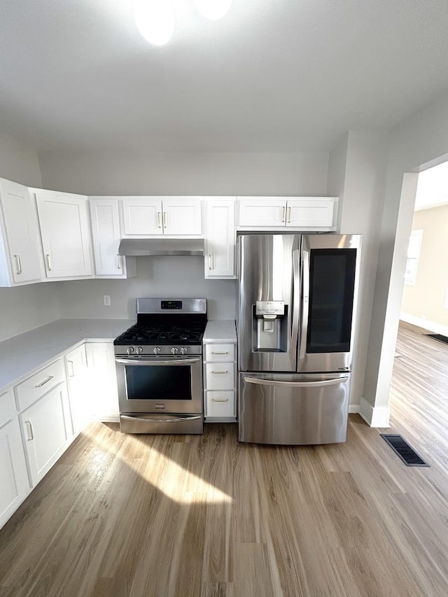 kitchen featuring light hardwood / wood-style flooring, stainless steel appliances, and white cabinetry