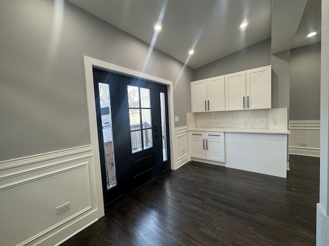 kitchen with white cabinets, dark hardwood / wood-style floors, and decorative backsplash