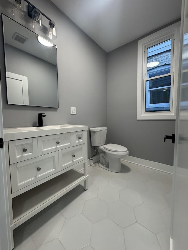 bathroom with tile patterned floors, vanity, and toilet