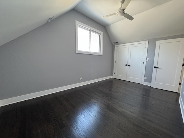 additional living space with ceiling fan, dark hardwood / wood-style flooring, and vaulted ceiling