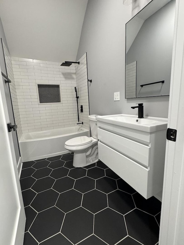 full bathroom with vanity, tile patterned floors, vaulted ceiling, tiled shower / bath combo, and toilet