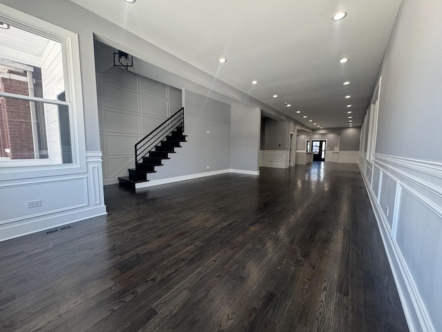 unfurnished living room featuring dark hardwood / wood-style flooring