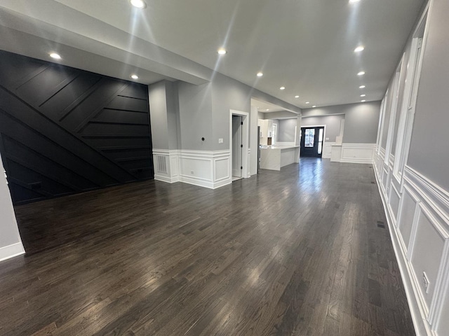 unfurnished living room with dark hardwood / wood-style flooring and french doors