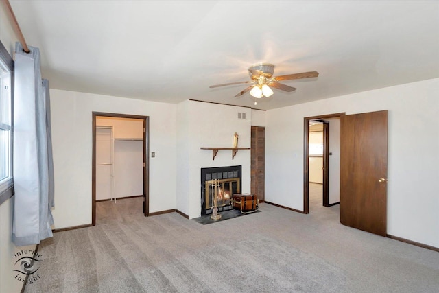 unfurnished living room featuring ceiling fan and light colored carpet