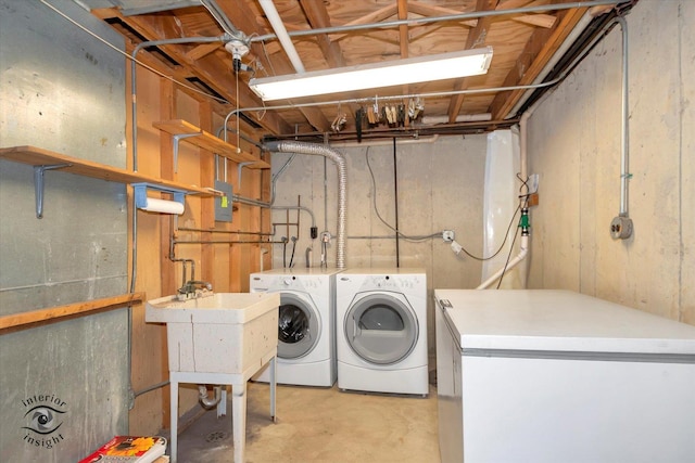 clothes washing area with washer and dryer and sink