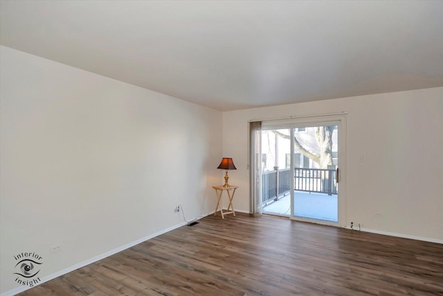 unfurnished room with dark hardwood / wood-style flooring