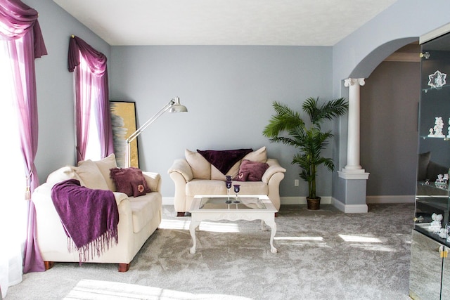 carpeted living room with ornate columns