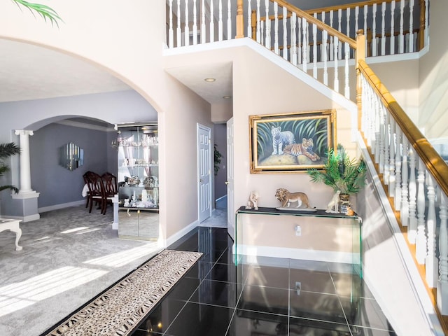 foyer entrance featuring a towering ceiling