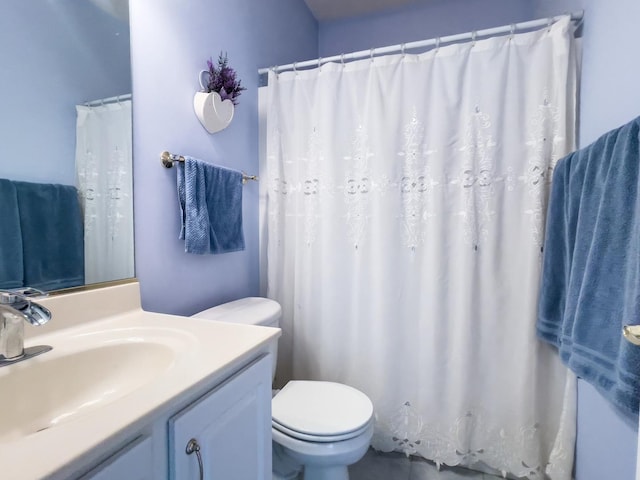 bathroom featuring toilet and vanity