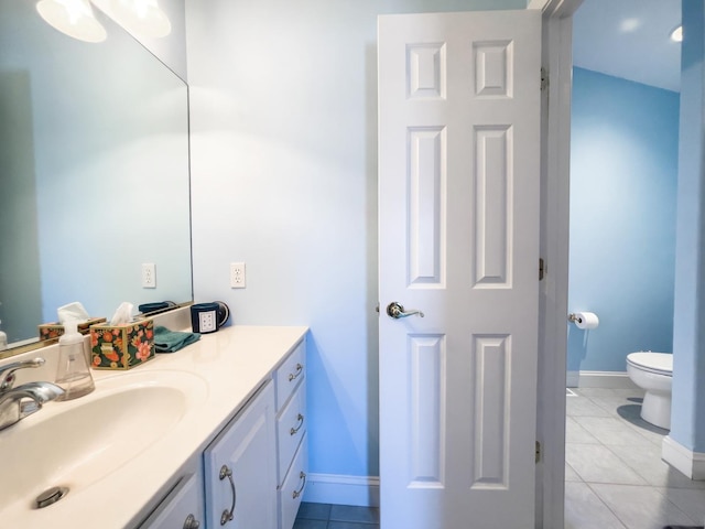 bathroom with vanity, tile patterned floors, and toilet