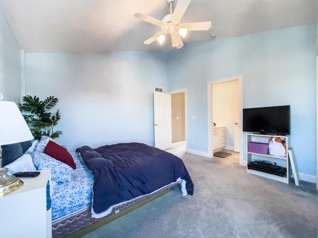 carpeted bedroom with a high ceiling, ensuite bath, and ceiling fan