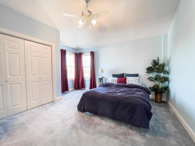 carpeted bedroom with ceiling fan and a closet