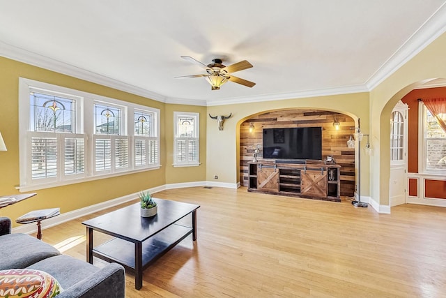 living room featuring ornamental molding, ceiling fan, and light hardwood / wood-style floors