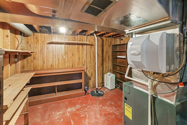 basement featuring wood walls