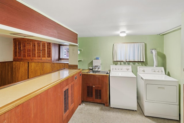 laundry area with cabinets and washer and clothes dryer