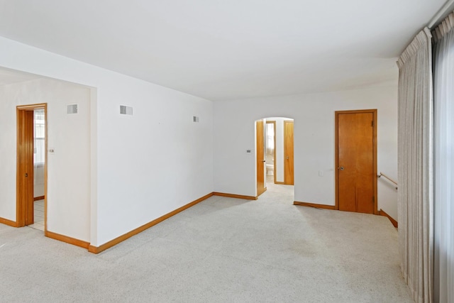 unfurnished room featuring light carpet