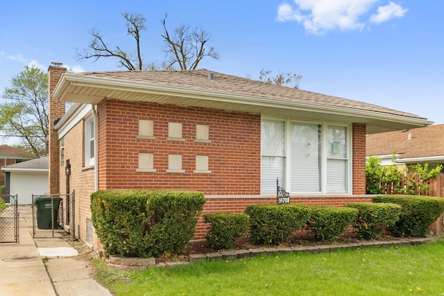 14708 Avalon Ave, Dolton, IL 60419 - view of front of property with a chimney, brick siding, fence, and a garage