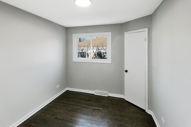 empty room with dark hardwood / wood-style floors