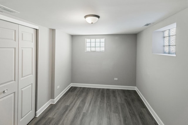 basement with dark hardwood / wood-style flooring