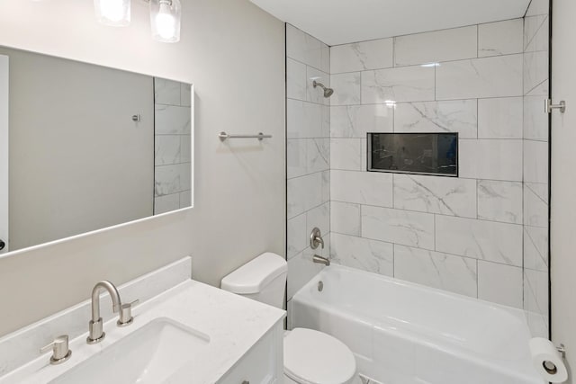 full bathroom featuring toilet, tiled shower / bath combo, and vanity