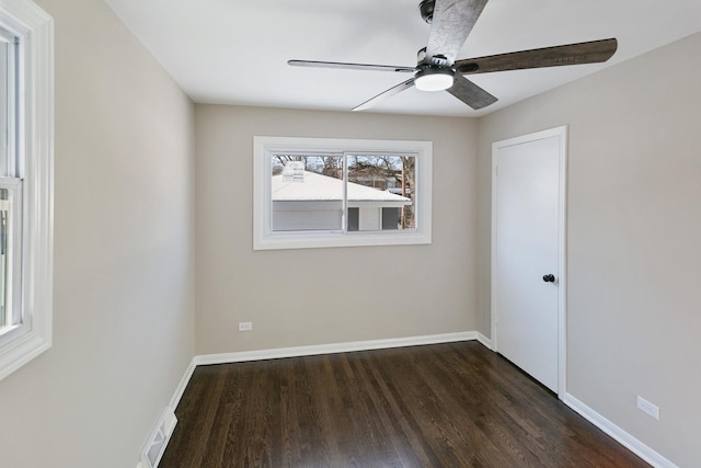 unfurnished room featuring dark wood-type flooring and ceiling fan