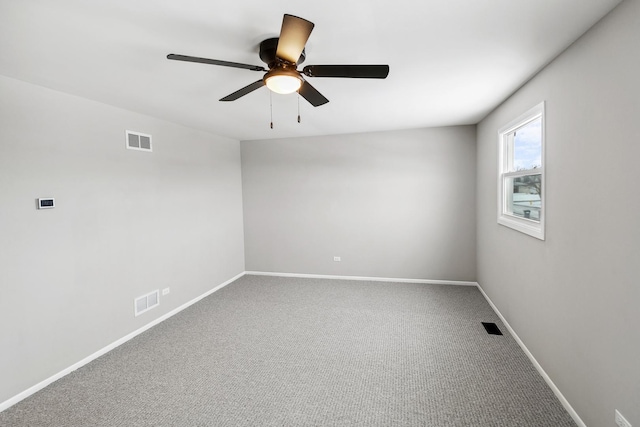 empty room with ceiling fan and carpet