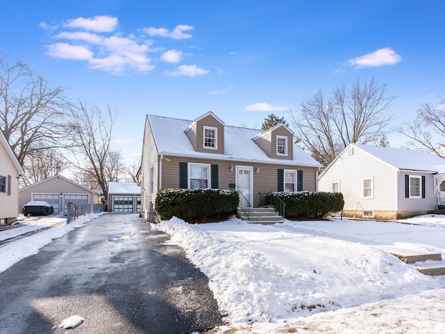 cape cod-style house with an outbuilding and a garage