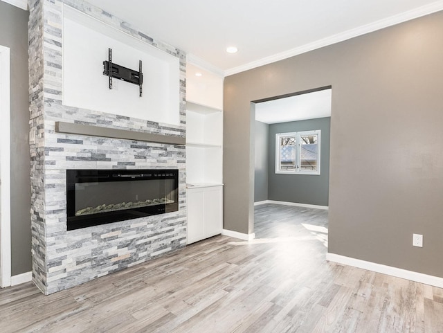 unfurnished living room with built in features, crown molding, and light hardwood / wood-style flooring