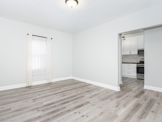 spare room with light hardwood / wood-style floors