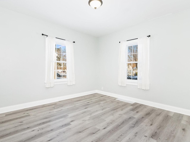 unfurnished room featuring light hardwood / wood-style flooring