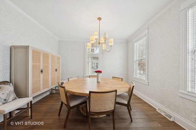 dining area with ornamental molding, dark hardwood / wood-style floors, and a notable chandelier