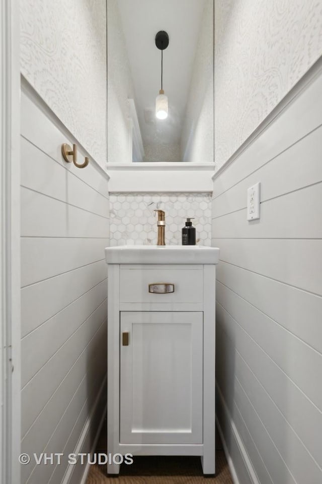 bathroom with wooden walls and vanity