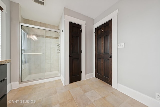 bathroom featuring a shower with door