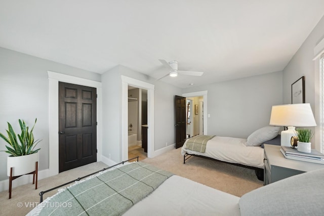 carpeted bedroom featuring ceiling fan and ensuite bathroom