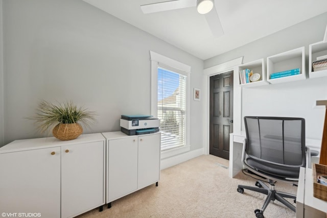 home office with ceiling fan and light carpet