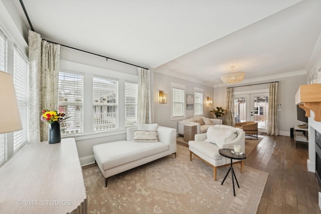 living room featuring french doors, crown molding, and hardwood / wood-style flooring