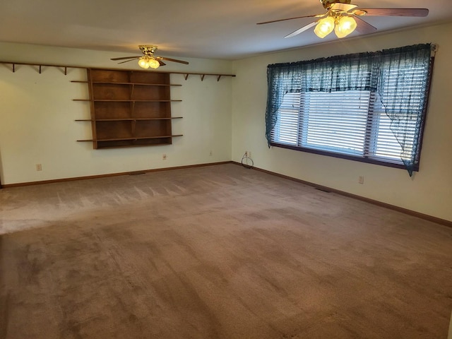 empty room with ceiling fan and carpet floors