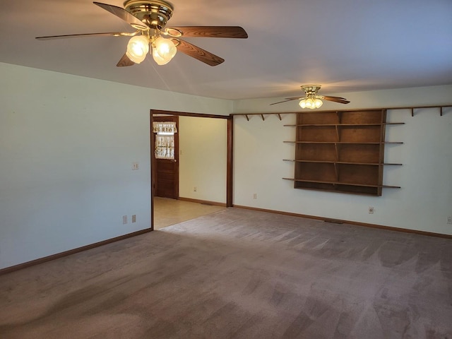 carpeted empty room featuring ceiling fan