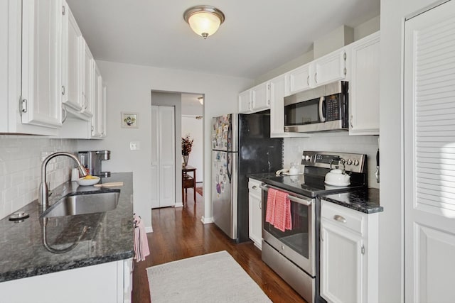 kitchen featuring sink, white cabinetry, backsplash, and stainless steel appliances